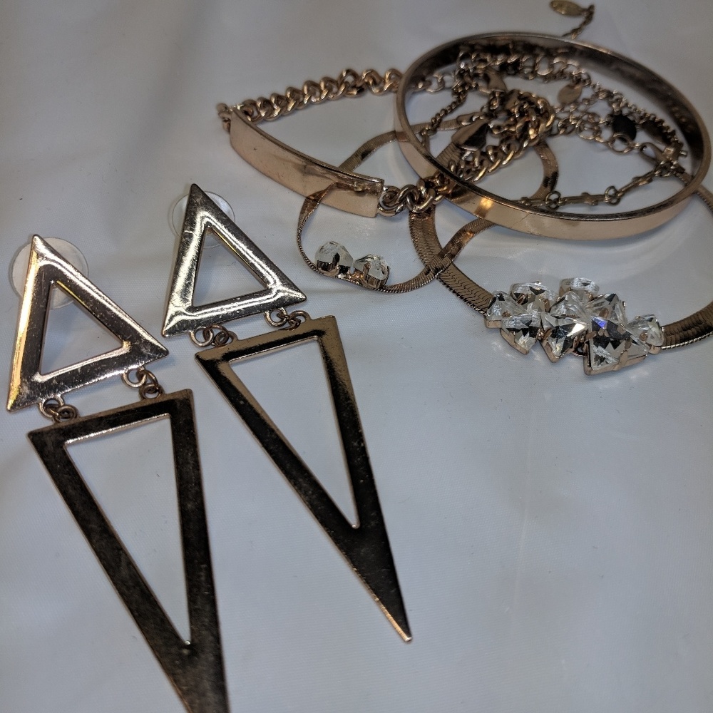 Gold bracelets and statement earrings